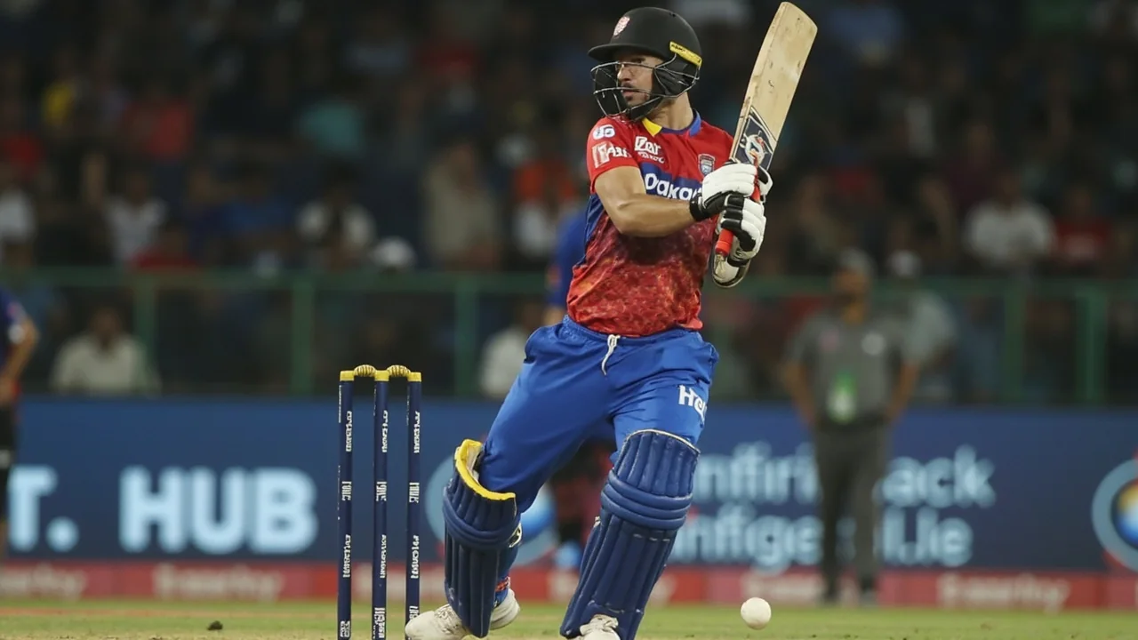 Batter driving on the off side during a Hundred Men's fixture, with a deep point fielder visible and the ball mid-flight over the inner ring